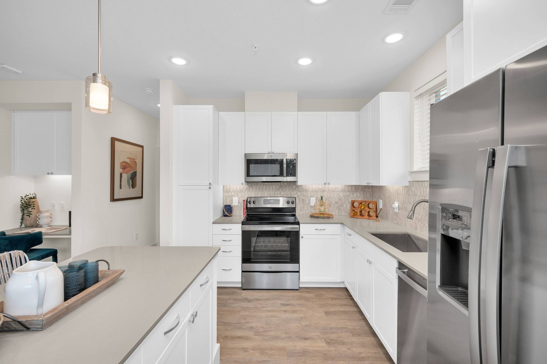 Luxury apartment kitchen with stainless steel appliances, granite countertops, and lots of storage space